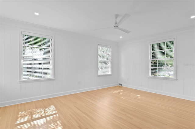 spare room featuring light hardwood / wood-style flooring, ornamental molding, and ceiling fan