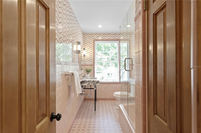 bathroom with tile walls, tile patterned floors, and toilet