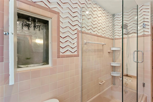 bathroom featuring bath / shower combo with glass door