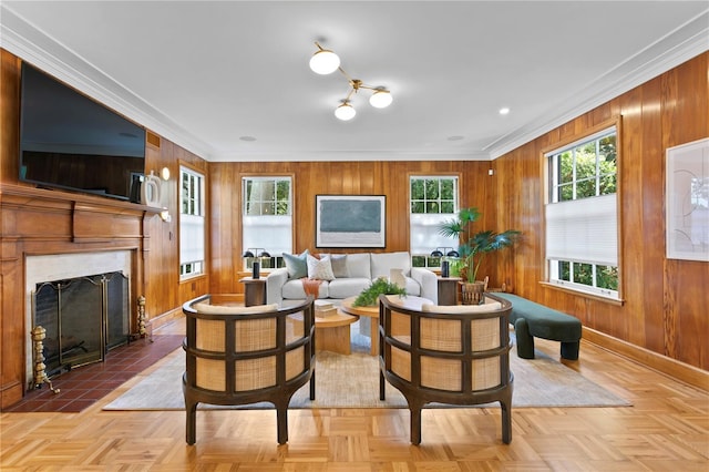 living room with ornamental molding, wooden walls, and light parquet floors