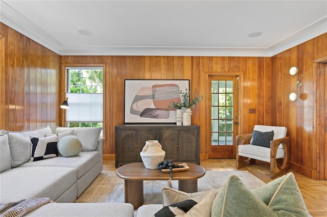 living room featuring ornamental molding, light parquet floors, and wood walls