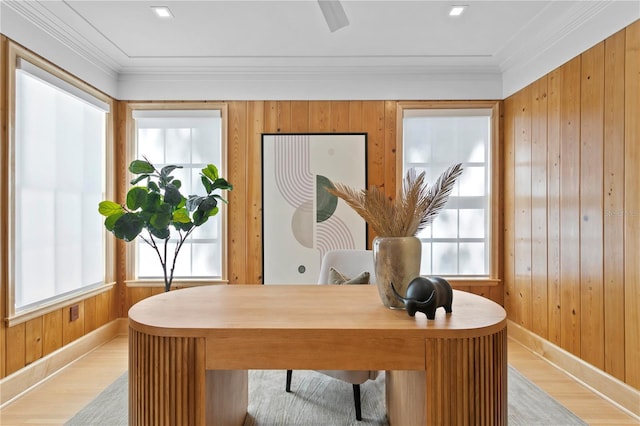 office with crown molding, wooden walls, and light hardwood / wood-style floors