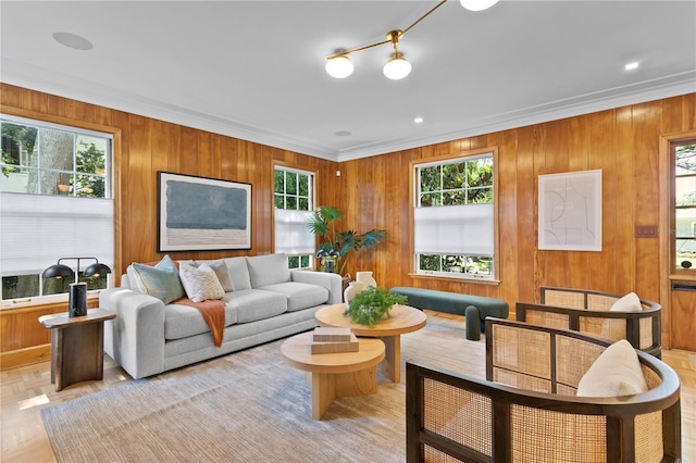 living room with ornamental molding, light parquet flooring, and wooden walls