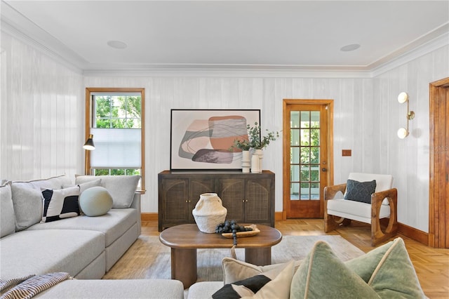 living room with crown molding, plenty of natural light, and light parquet floors