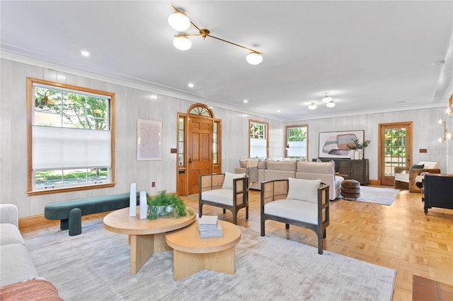 living room with ornamental molding and light parquet flooring