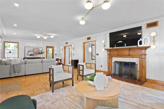 living room with crown molding and parquet flooring