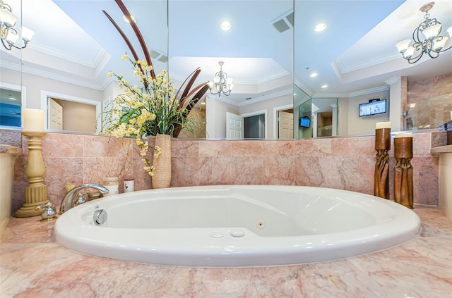 bathroom with tile walls, a relaxing tiled bath, and a raised ceiling