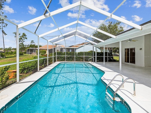 view of swimming pool with ceiling fan, a lanai, and a patio