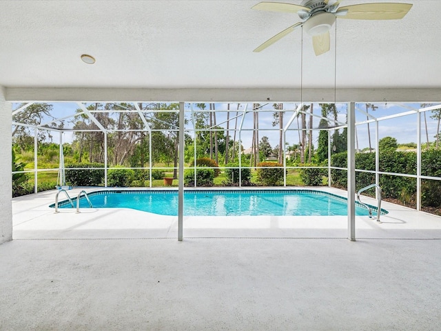 view of pool with a patio, ceiling fan, and a lanai