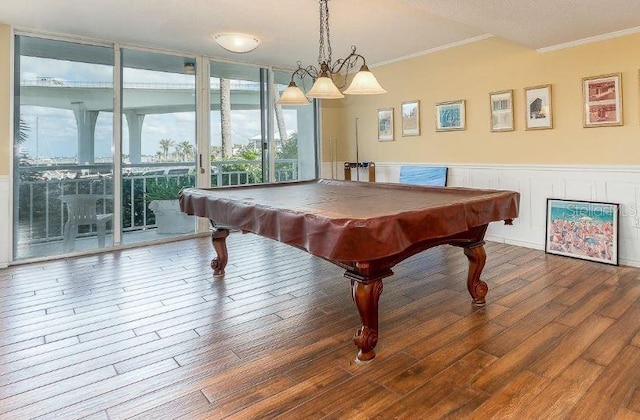 rec room featuring pool table, a wall of windows, hardwood / wood-style floors, and crown molding