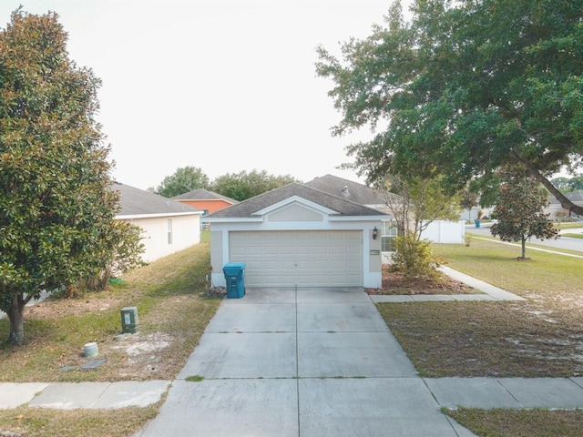 ranch-style home featuring a garage and a front lawn