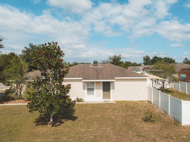 back of house with a lawn