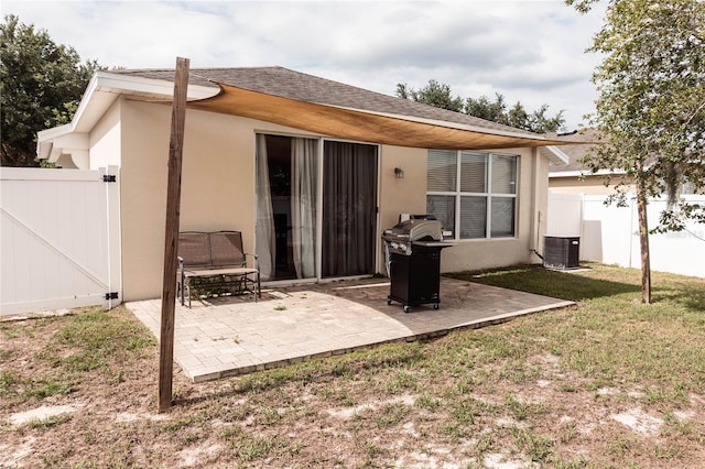 back of property featuring a patio area, central AC, and a yard