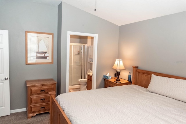 carpeted bedroom featuring vaulted ceiling and ensuite bath