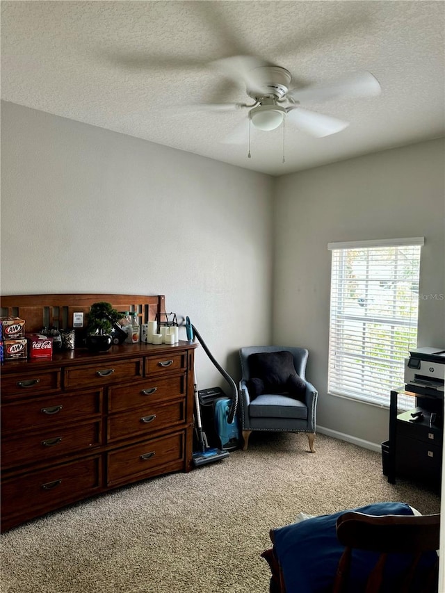 sitting room featuring a textured ceiling, light colored carpet, and ceiling fan