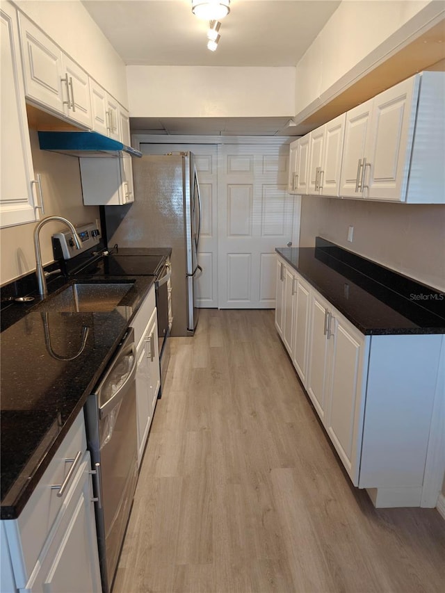 kitchen featuring dishwasher, light wood-type flooring, white cabinetry, and a sink