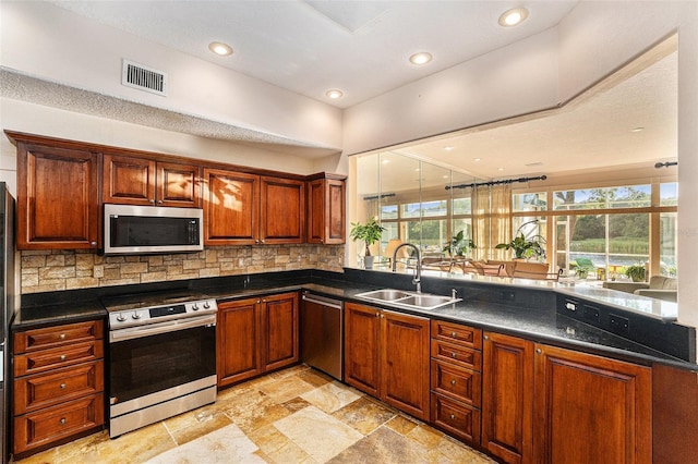 kitchen featuring stainless steel appliances, tasteful backsplash, and sink