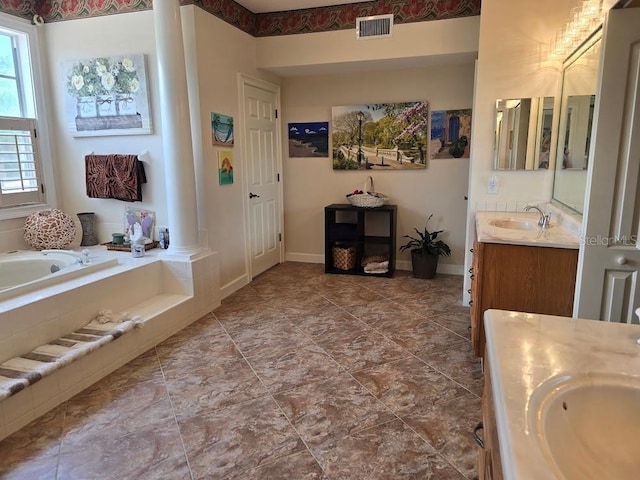 bathroom featuring tiled bath and vanity