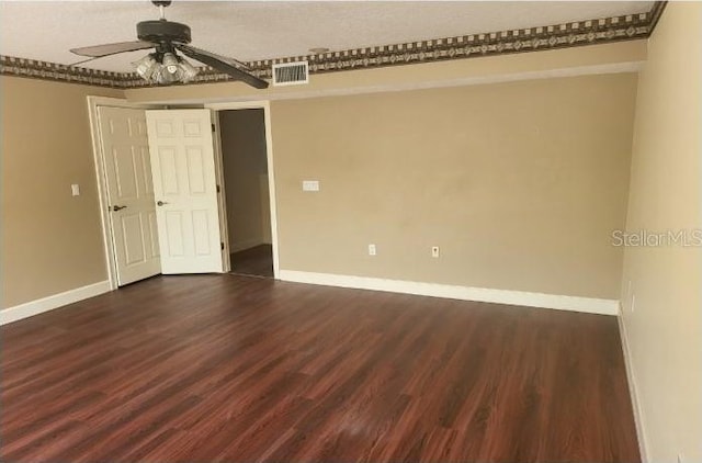 empty room featuring ceiling fan and dark hardwood / wood-style floors