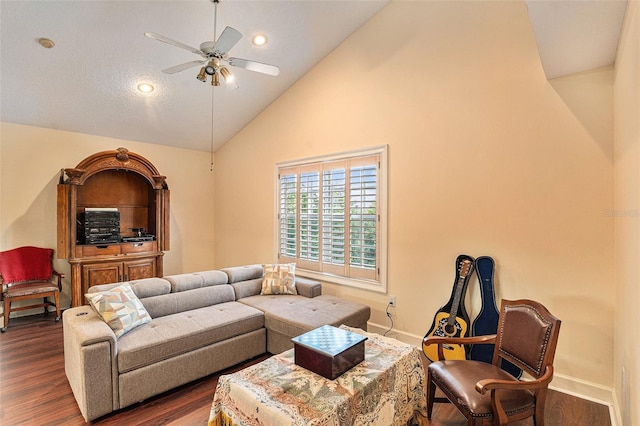 living room with lofted ceiling, ceiling fan, and dark hardwood / wood-style flooring