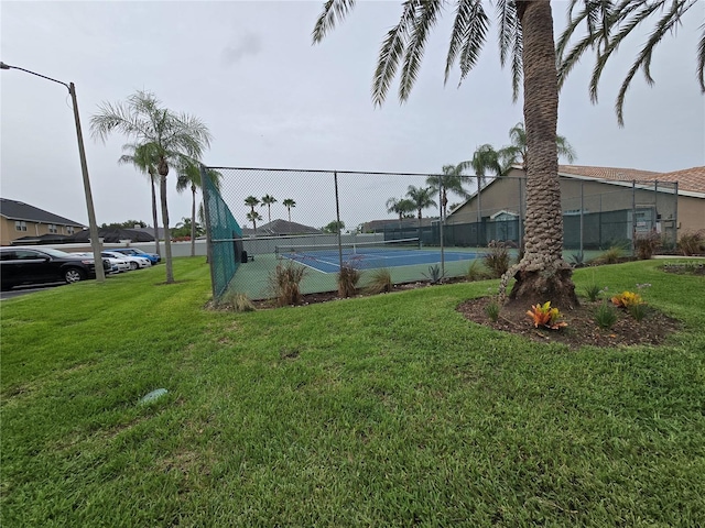 view of sport court featuring a lawn