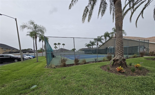 view of sport court featuring a yard