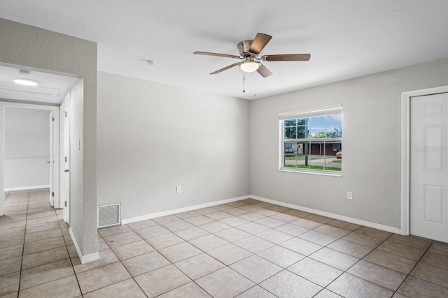 tiled empty room with ceiling fan