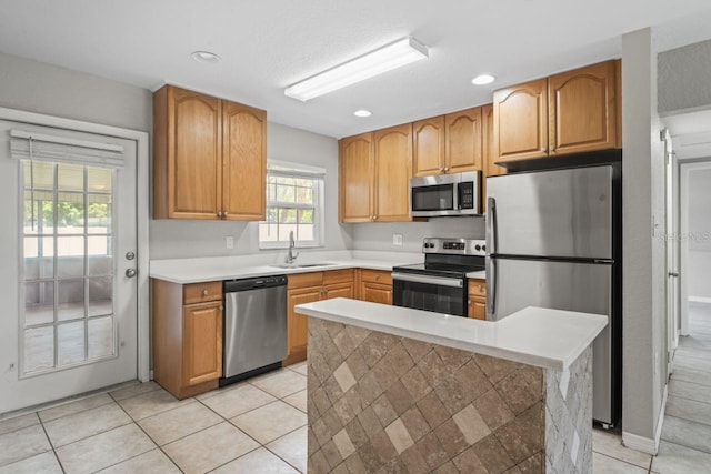 kitchen featuring sink, stainless steel appliances, and light tile patterned flooring