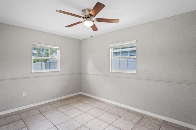 unfurnished room featuring light tile patterned floors and ceiling fan