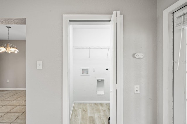 washroom with an inviting chandelier, hookup for a washing machine, and electric dryer hookup