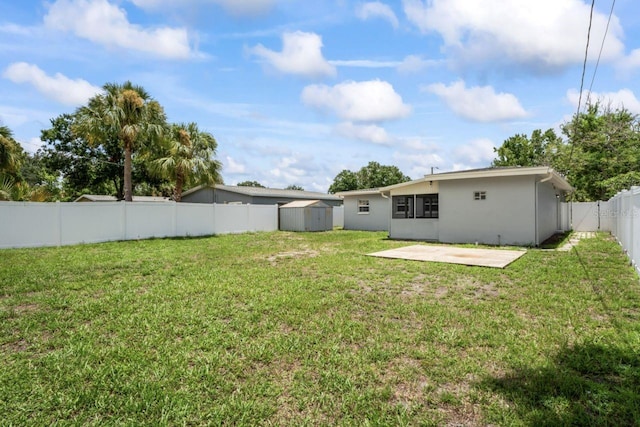 view of yard featuring a shed and a patio