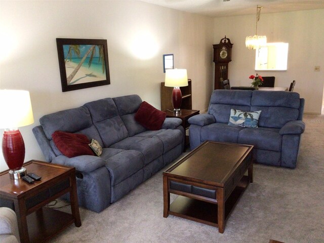 living room with carpet floors and a notable chandelier