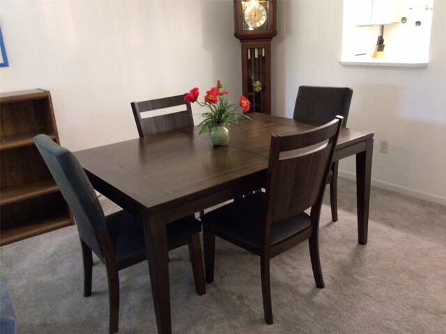 dining space with light colored carpet