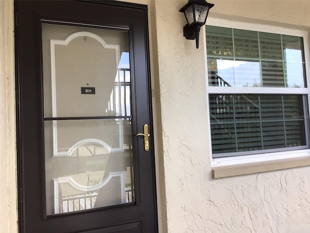 doorway to property with stucco siding