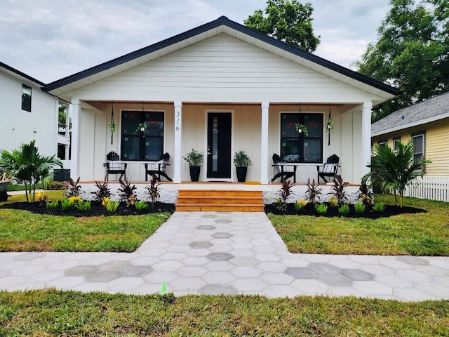 view of front of home featuring a front yard and a porch