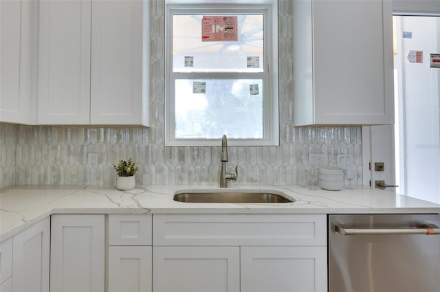 kitchen featuring sink, dishwasher, white cabinetry, and light stone counters