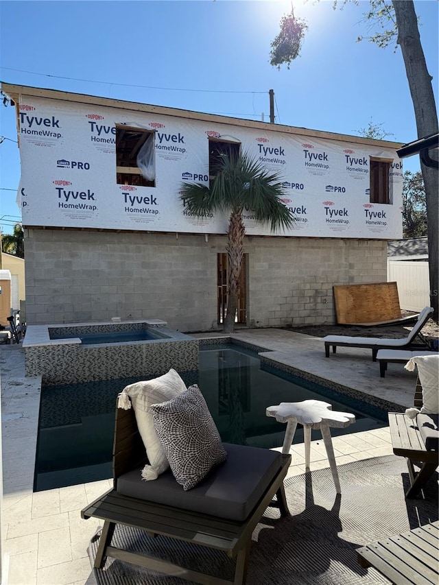 view of patio / terrace with a pool with hot tub