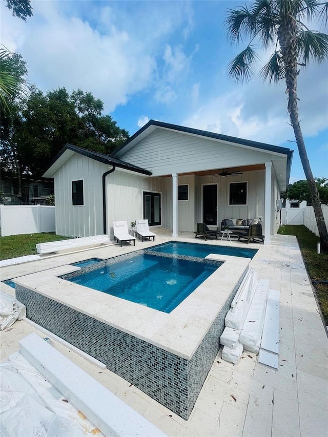 view of swimming pool featuring a patio and ceiling fan