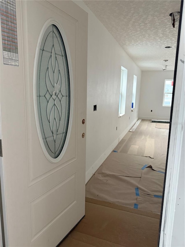 foyer with a textured ceiling