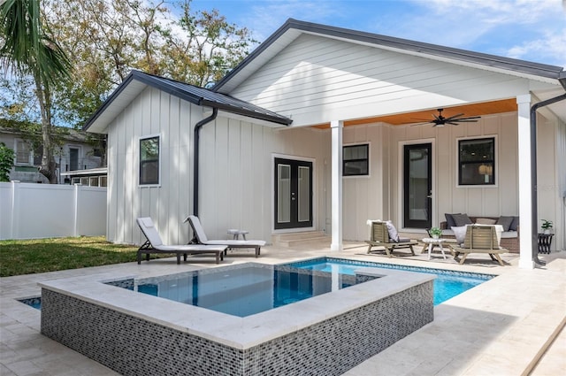 back of house with ceiling fan, metal roof, fence, french doors, and board and batten siding