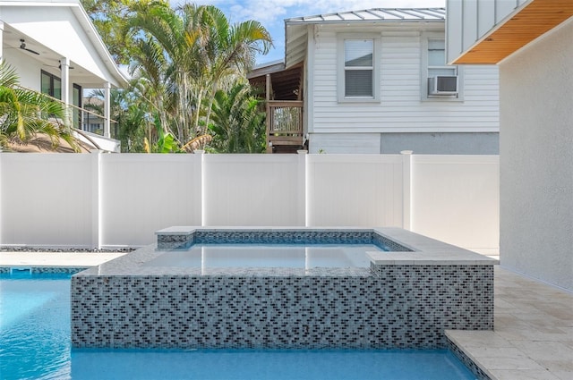 view of pool with a fenced in pool, fence, a patio, and an in ground hot tub