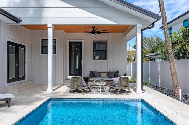 view of swimming pool with a patio, an outdoor hangout area, fence, a ceiling fan, and a fenced in pool