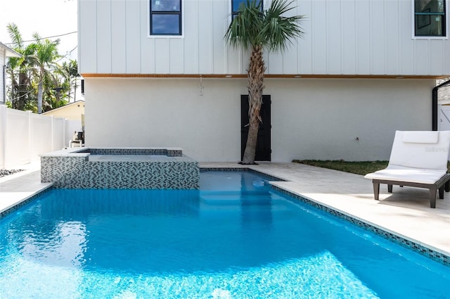 view of swimming pool featuring an in ground hot tub, a patio area, fence, and a fenced in pool