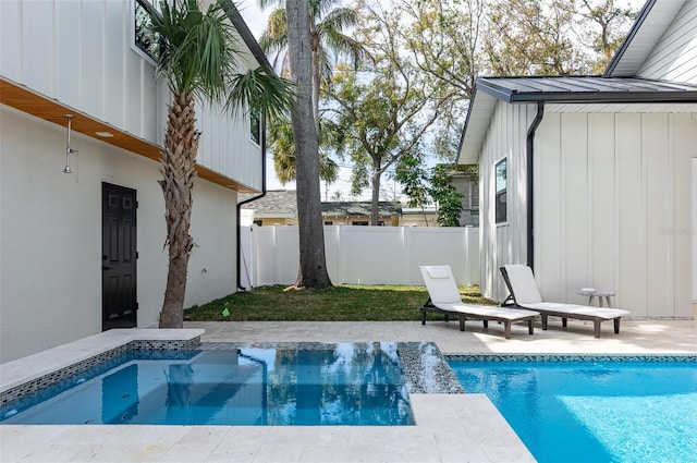 view of swimming pool with a fenced in pool, fence, and a patio