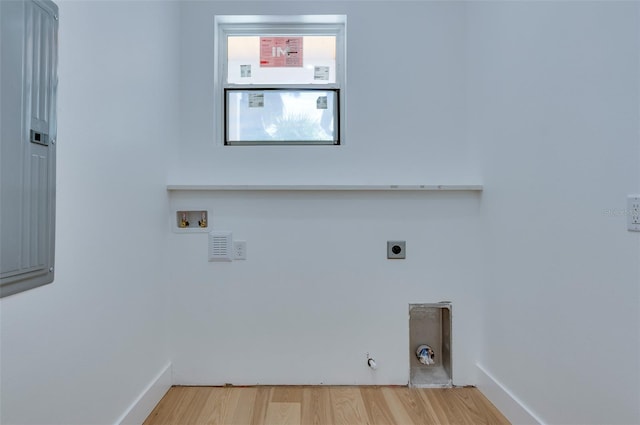 washroom featuring hookup for a gas dryer, laundry area, washer hookup, wood finished floors, and electric dryer hookup