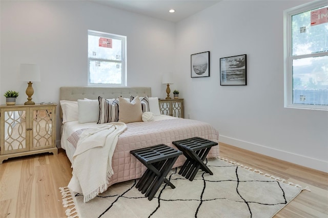 bedroom featuring light wood-type flooring, baseboards, and recessed lighting