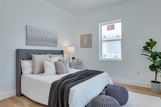 bedroom featuring baseboards and light wood-style floors