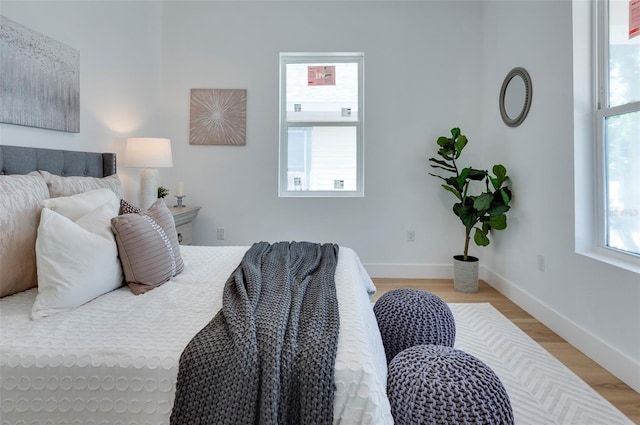 bedroom with light wood-style floors and baseboards