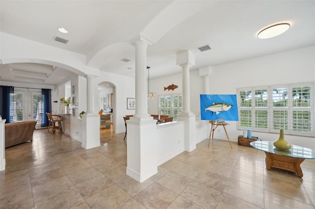 kitchen with kitchen peninsula, french doors, and a healthy amount of sunlight