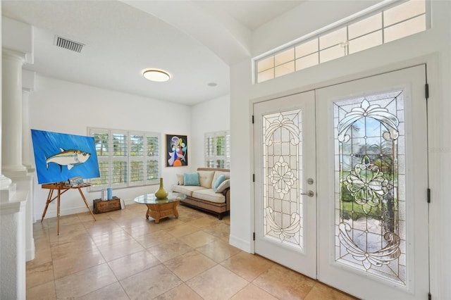 foyer with french doors, light tile patterned floors, and plenty of natural light